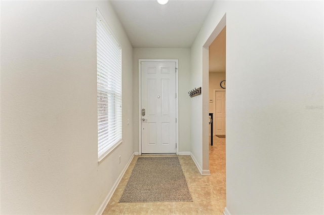 entryway featuring baseboards