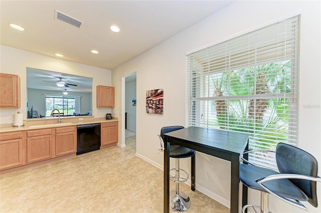 kitchen featuring recessed lighting, light countertops, visible vents, a sink, and dishwasher