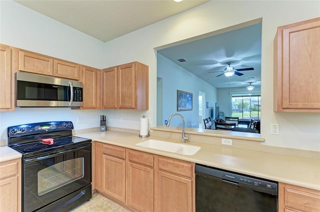 kitchen with light brown cabinets, a sink, visible vents, light countertops, and black appliances