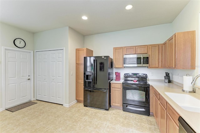 kitchen featuring recessed lighting, a sink, baseboards, light countertops, and black appliances