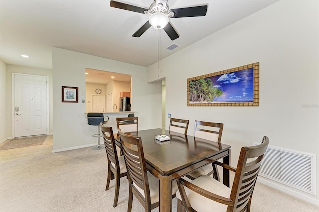 dining space with light carpet, baseboards, visible vents, and recessed lighting