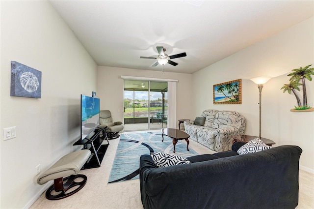 living room with carpet floors, baseboards, and a ceiling fan