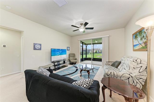 carpeted living area with ceiling fan, a sunroom, visible vents, and baseboards