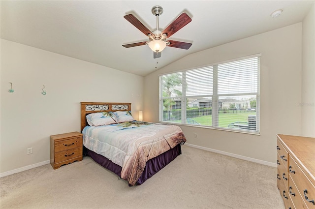 bedroom featuring lofted ceiling, light carpet, baseboards, and a ceiling fan