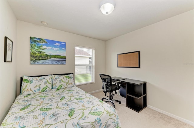 bedroom with light carpet and baseboards