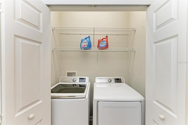 clothes washing area with washing machine and dryer and laundry area