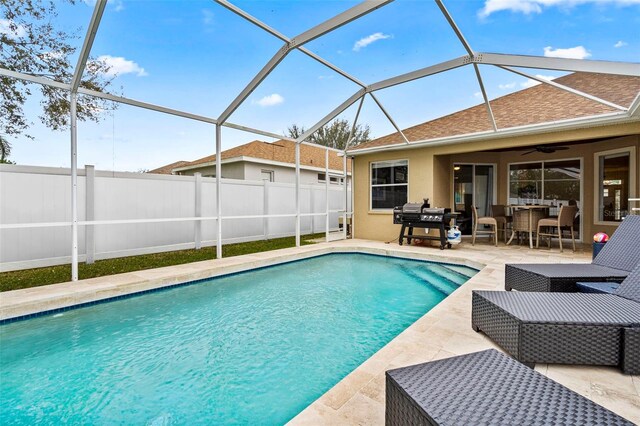 view of pool featuring a fenced backyard, a lanai, a ceiling fan, a fenced in pool, and a patio area