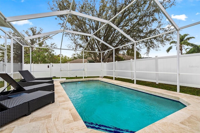 view of swimming pool featuring a patio, a fenced backyard, a fenced in pool, and a lanai