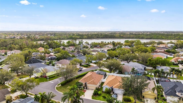 birds eye view of property with a water view and a residential view