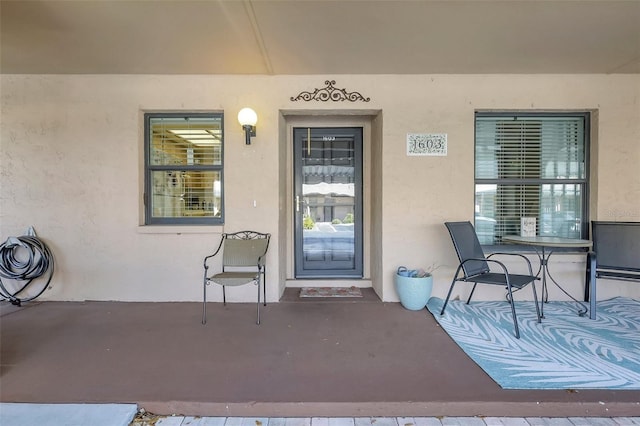 entrance to property featuring stucco siding