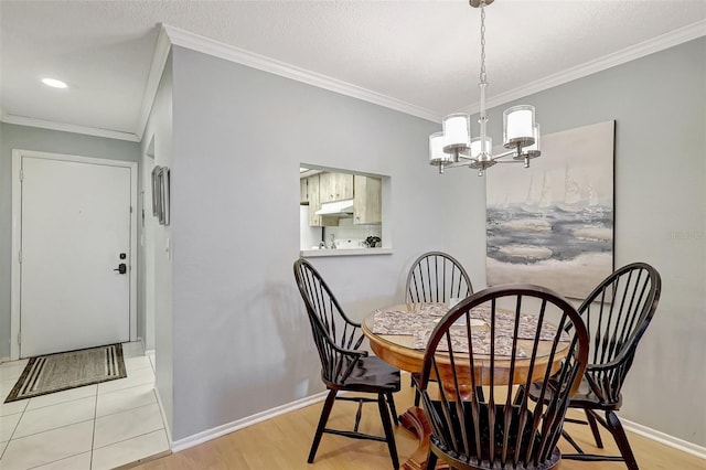 dining room with baseboards, a chandelier, and crown molding