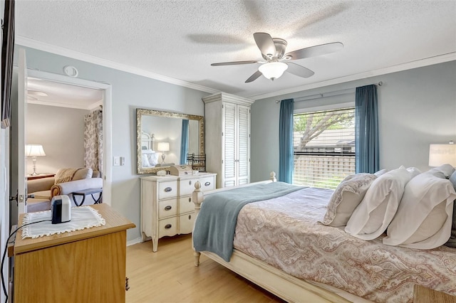 bedroom featuring crown molding, ceiling fan, a textured ceiling, and light wood-style floors