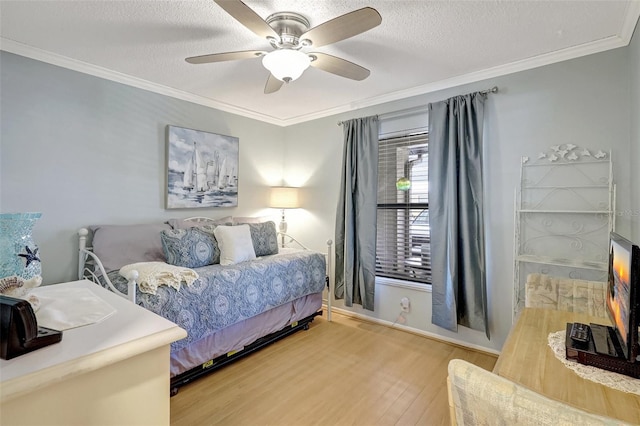 bedroom featuring crown molding, a textured ceiling, a ceiling fan, and wood finished floors