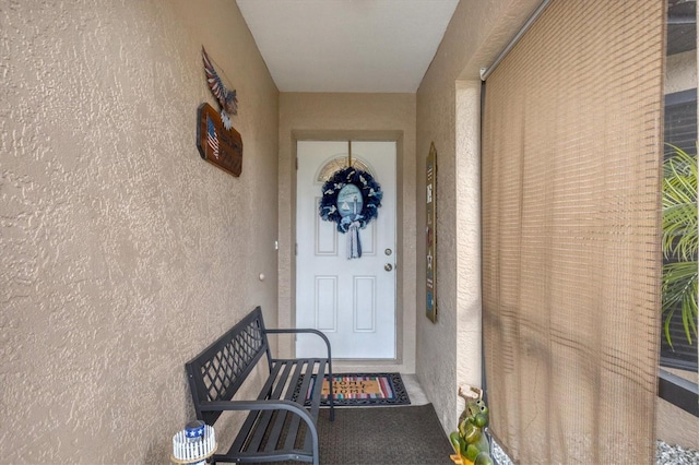 view of exterior entry with stucco siding