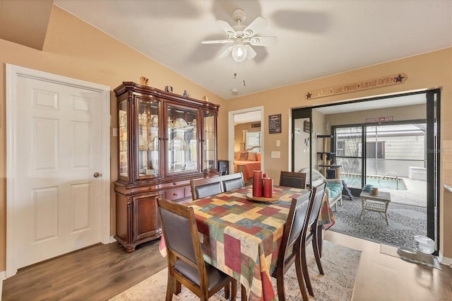 dining area featuring vaulted ceiling, ceiling fan, and wood finished floors