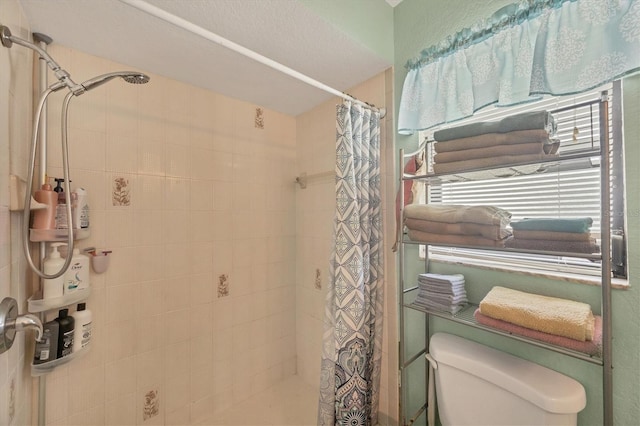 full bathroom with toilet and a shower stall