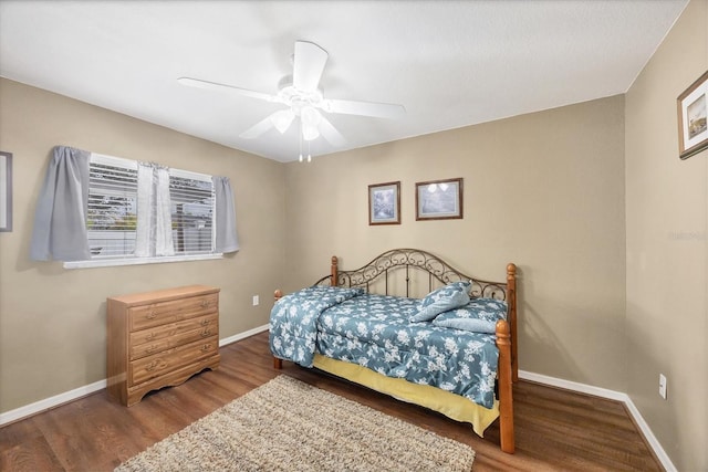 bedroom with ceiling fan, baseboards, and wood finished floors