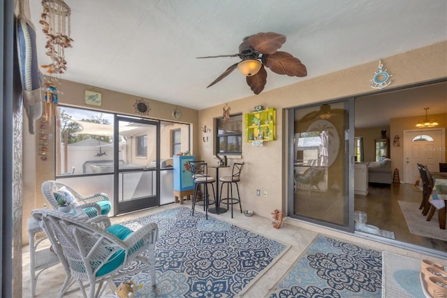 sunroom featuring a ceiling fan