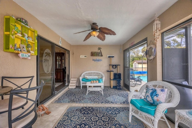 sunroom featuring a ceiling fan