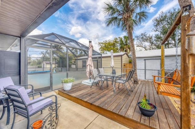 wooden terrace with outdoor dining space and a lanai