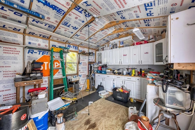 kitchen featuring vaulted ceiling, glass insert cabinets, and white cabinets