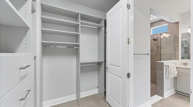 spacious closet with light tile patterned flooring