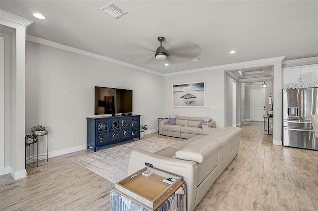 living area featuring visible vents, light wood-style floors, ceiling fan, and ornamental molding