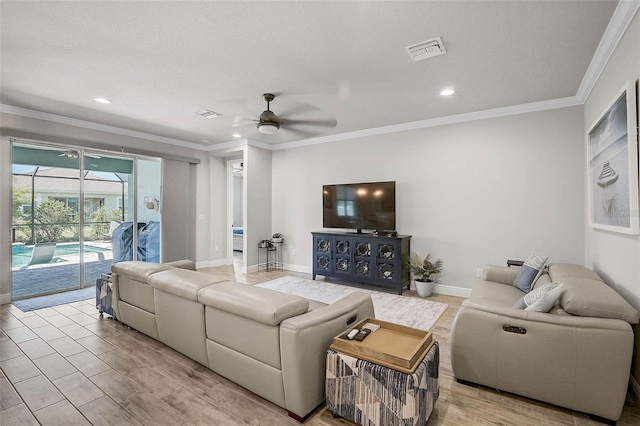 living room with visible vents, baseboards, crown molding, and a sunroom