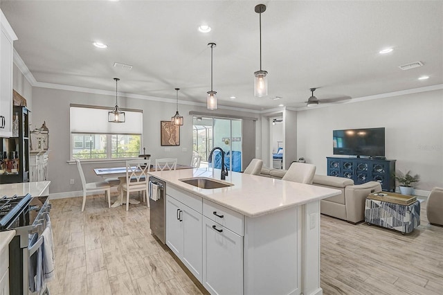 kitchen with visible vents, plenty of natural light, ornamental molding, a sink, and appliances with stainless steel finishes