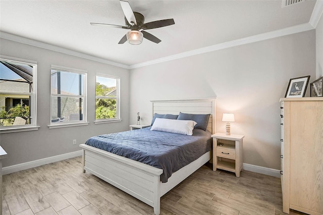 bedroom featuring ceiling fan, baseboards, light wood-style flooring, and ornamental molding