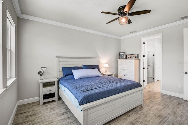 bedroom with visible vents, baseboards, ornamental molding, wood finished floors, and a ceiling fan