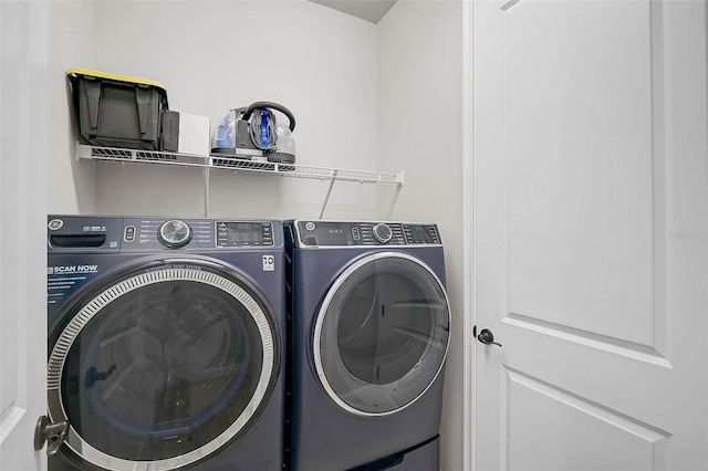 laundry area with laundry area and washer and clothes dryer