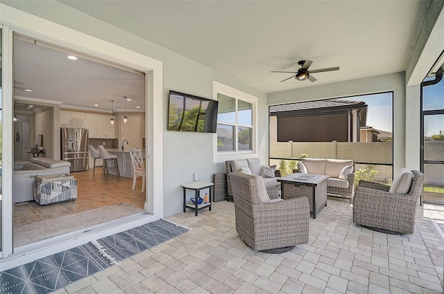 view of patio with a sink, an outdoor hangout area, and ceiling fan