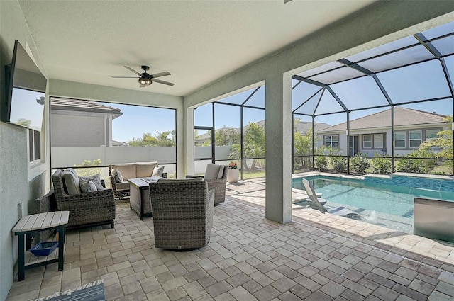 view of swimming pool featuring a lanai, an outdoor hangout area, ceiling fan, and a patio area