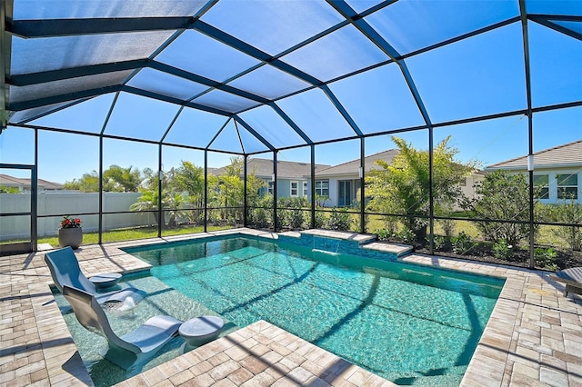 view of pool with glass enclosure, a fenced in pool, and a patio area