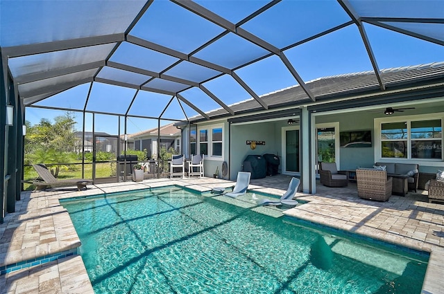 pool with an outdoor hangout area, a lanai, a ceiling fan, and a patio area