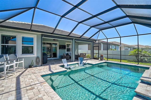 view of pool with a fenced in pool, a lanai, a ceiling fan, and a patio area