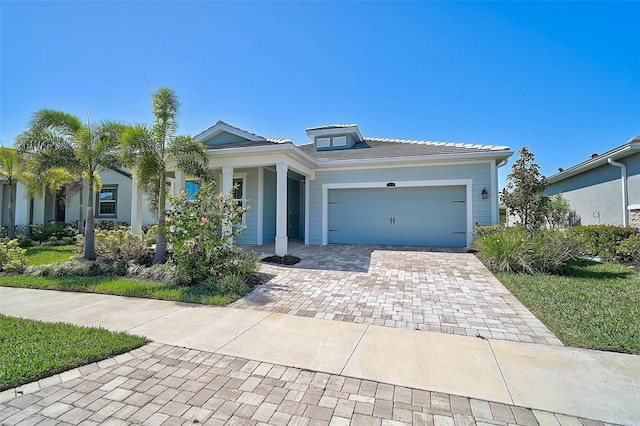 view of front facade with decorative driveway and a garage