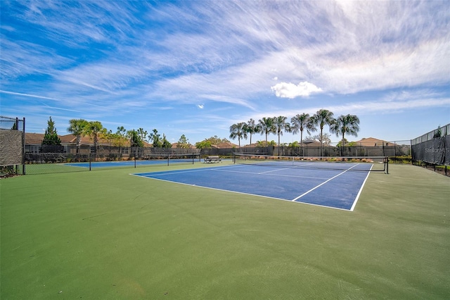 view of sport court featuring fence