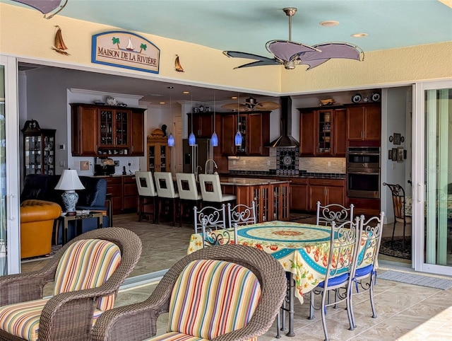 dining room featuring light tile patterned flooring and ceiling fan