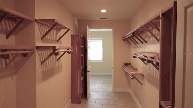 spacious closet featuring visible vents