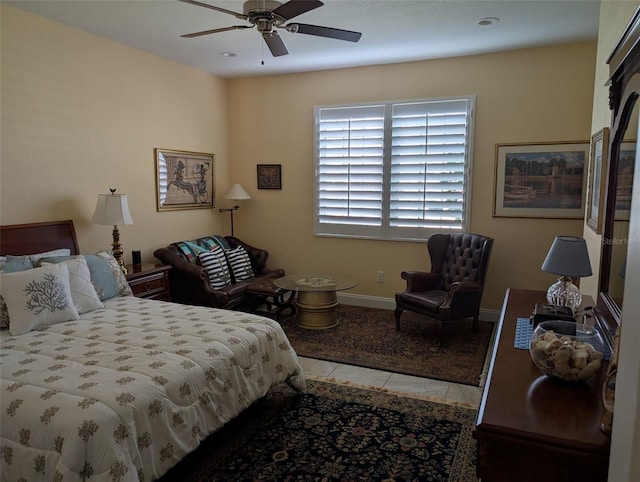 bedroom with a ceiling fan, light tile patterned flooring, and baseboards