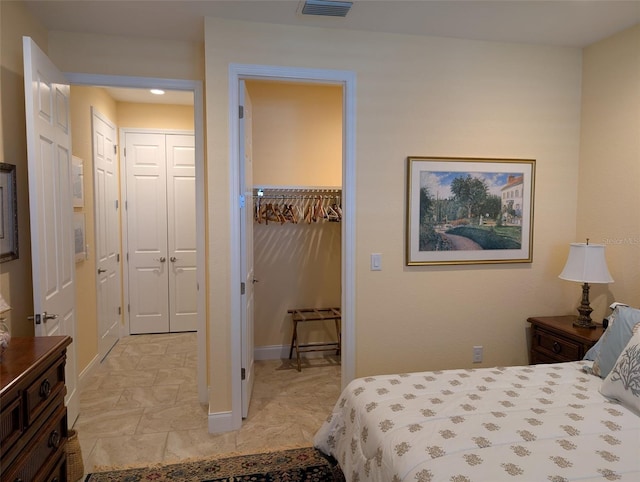 bedroom featuring a spacious closet, visible vents, and a closet