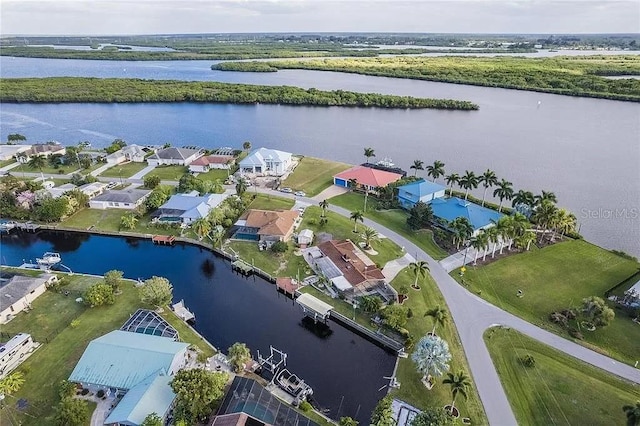 birds eye view of property with a water view and a residential view