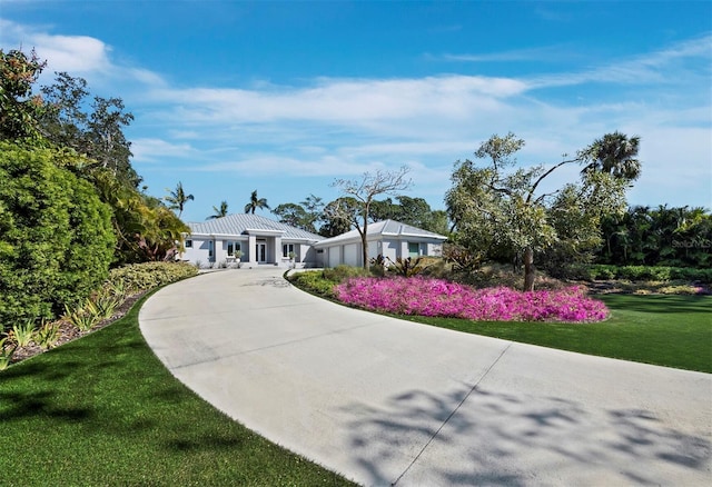 ranch-style home with a garage, driveway, and a front yard