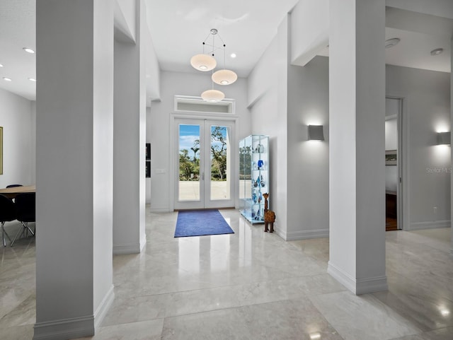 foyer with french doors, recessed lighting, and baseboards