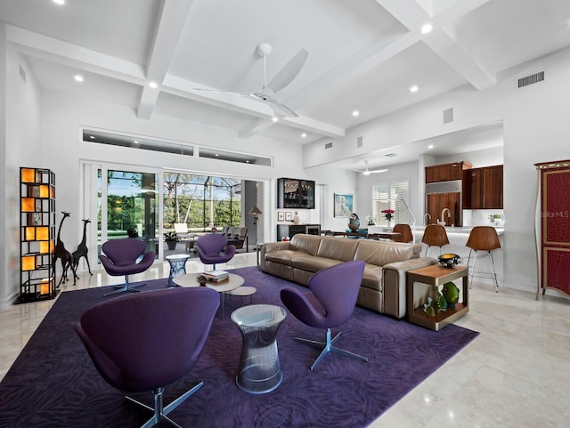 living area featuring visible vents, beamed ceiling, coffered ceiling, and a ceiling fan