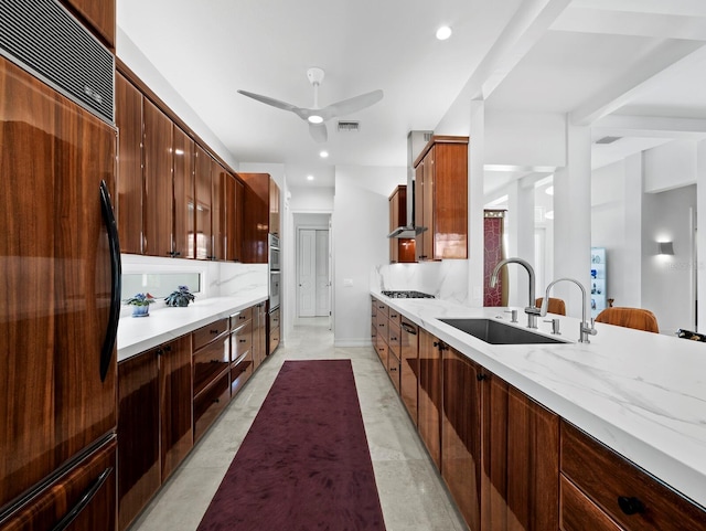 kitchen featuring tasteful backsplash, modern cabinets, a sink, light stone countertops, and fridge