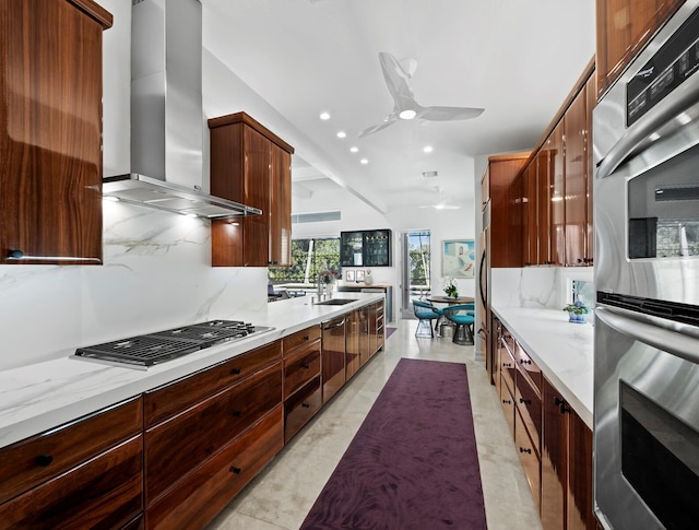 kitchen with wall chimney range hood, modern cabinets, stainless steel appliances, and decorative backsplash