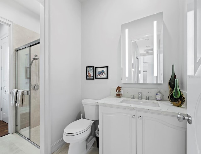 full bathroom with a stall shower, vanity, and toilet